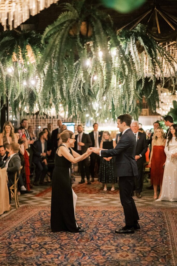groom and mother of groom dance at wedding reception