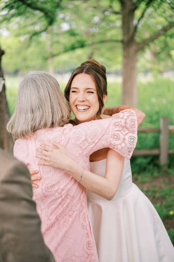 bride hugging mother of the groom at wedding