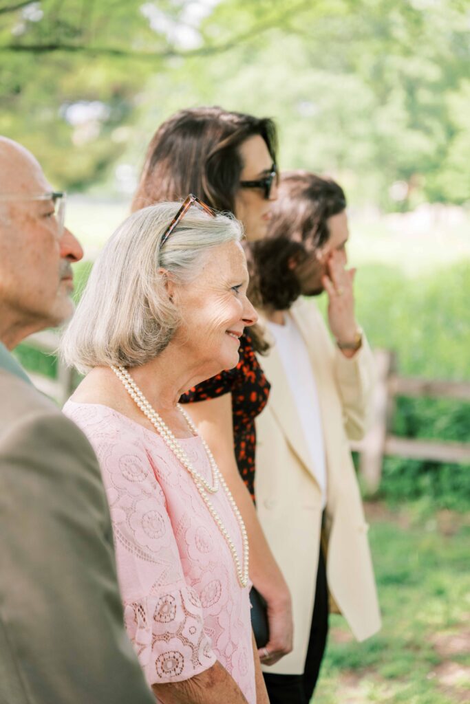 wedding guest photos; mother of the groom watching wedding ceremony