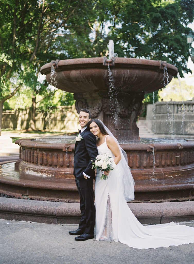 bride and groom portraits in front of fountain