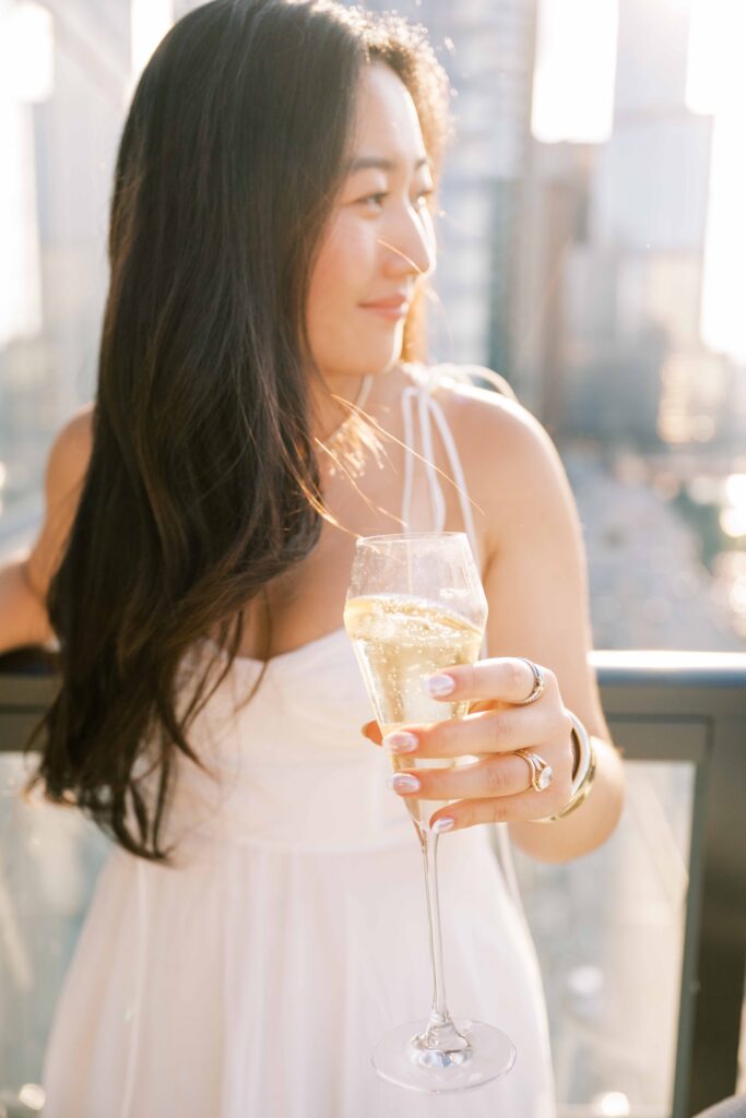 champagne bubbles and engagement ring; golden hour rooftop engagement photos