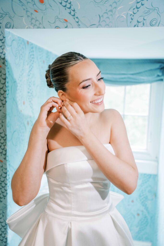 bride getting ready putting on jewelry photos