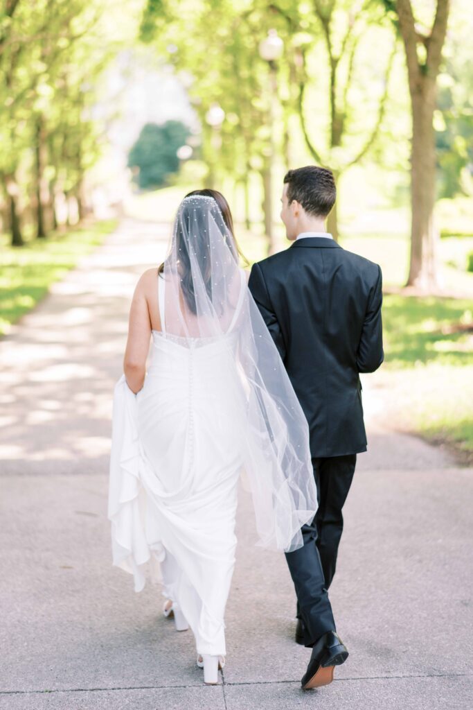 newlywed couple walking down sidewalk