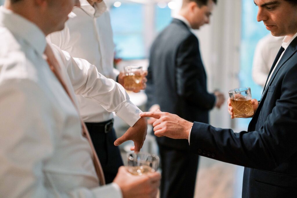 groomsmen drinking whiskey and getting ready