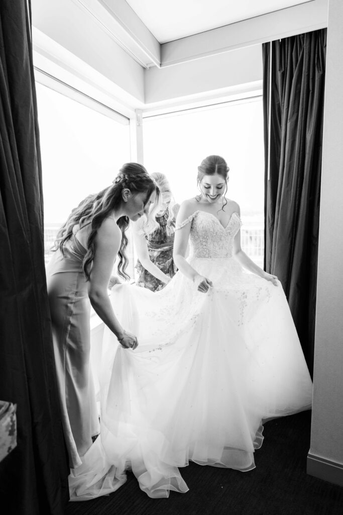 bride putting on dress 