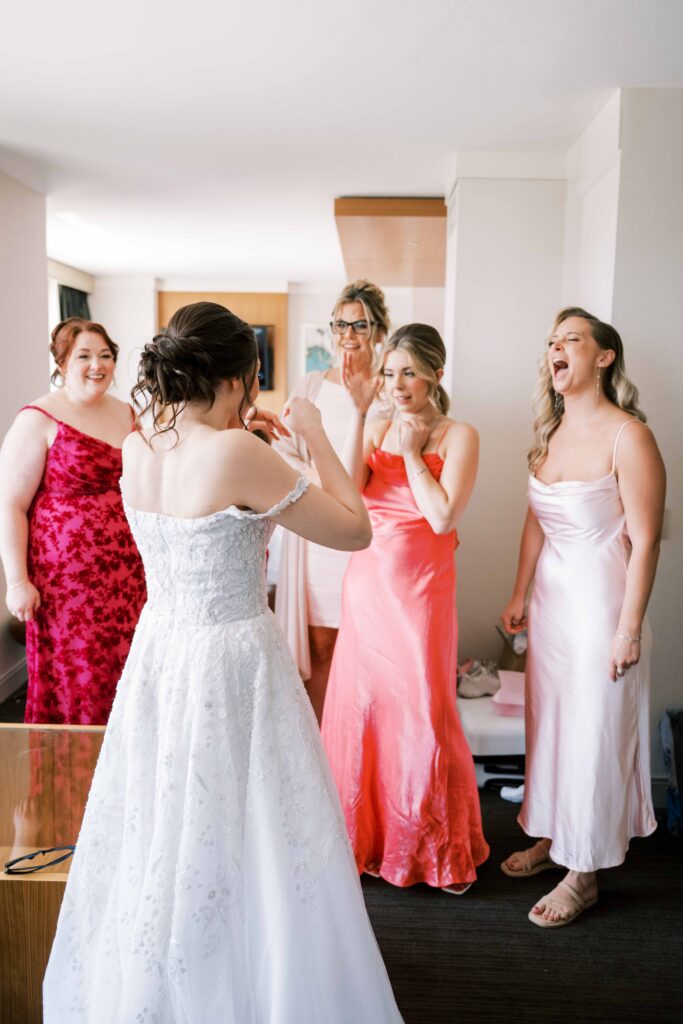 bride first look with bridesmaids